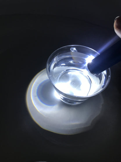Making rainbows with glass of water and flashlight